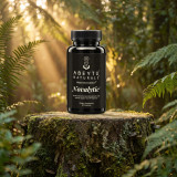 Novalytic by Abeytú Naturals on a moss-covered tree stump in a sunlit fern forest
