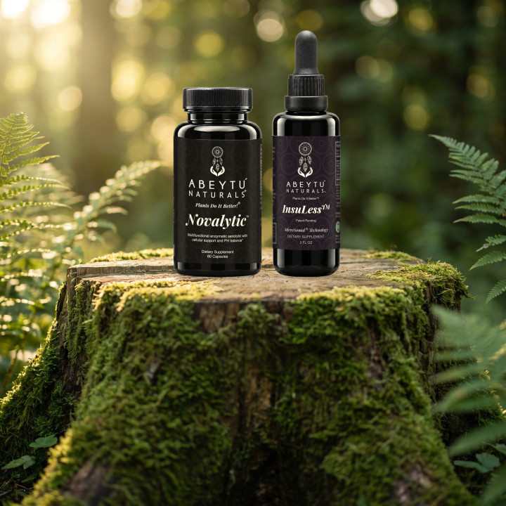 Novalytic and InsuLess bottles on a moss-covered tree stump in a sunlit fern glade