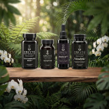 The four Maria’s Protocol bottles on a walnut slab among rainforest ferns and white orchids