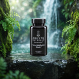 Toxin Mobilization Binder bottle on wet basalt beside a clear forest waterfall